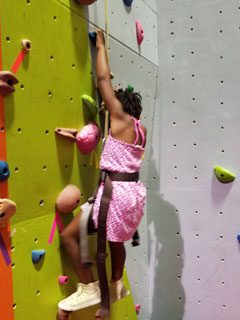 Girl indoor rock climbing